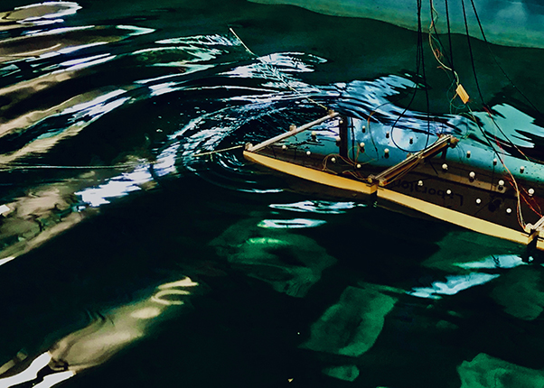 A hinged platform floating in a large tank of water A hinged platform floating in a large tank of water
