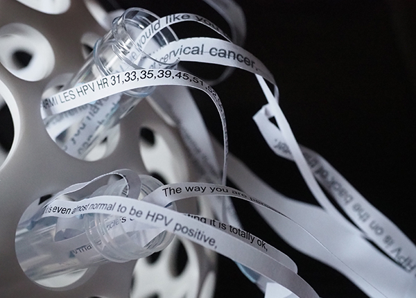 A sculpture made from strips of patient letters flowing out of test tubes A sculpture made from strips of patient letters flowing out of test tubes