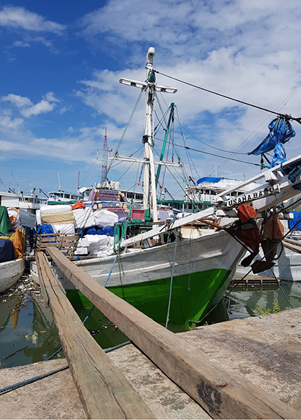 An Indonesian fishing boat moored in a marina An Indonesian fishing boat moored in a marina