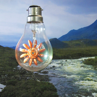 A light bulb containing a turbine hanging in mid-air above a stream leading to mountains A light bulb containing a turbine hanging in mid-air above a stream leading to mountains