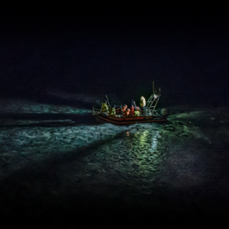 A boat with researchers in the middle of the ocean at night A boat with researchers in the middle of the ocean at night