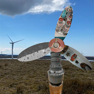 Wind turbine components in a skip next to a mocked up turbine made from old parts Wind turbine components in a skip next to a mocked up turbine made from old parts