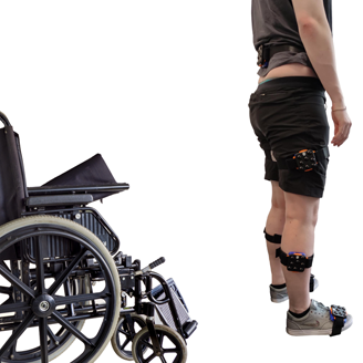 A wheelchair, followed by a person standing, followed by a person walking away A wheelchair, followed by a person standing, followed by a person walking away