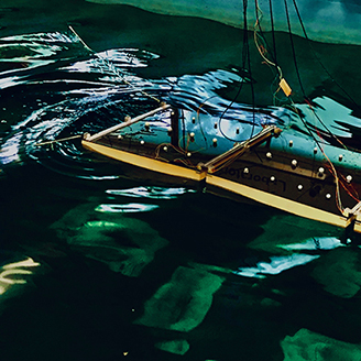A hinged platform floating in a large tank of water A hinged platform floating in a large tank of water