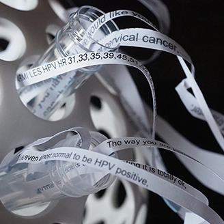 A sculpture made from strips of patient letters flowing out of test tubes A sculpture made from strips of patient letters flowing out of test tubes