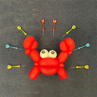 A red balloon crab, surrounded by darts with pictures of vesicles on them pointing at the crab A red balloon crab, surrounded by darts with pictures of vesicles on them pointing at the crab