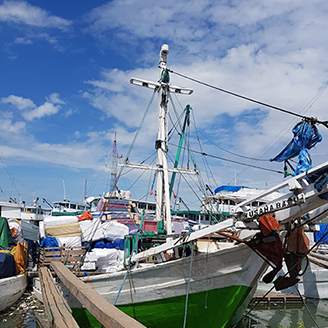An Indonesian fishing boat moored in a marina An Indonesian fishing boat moored in a marina