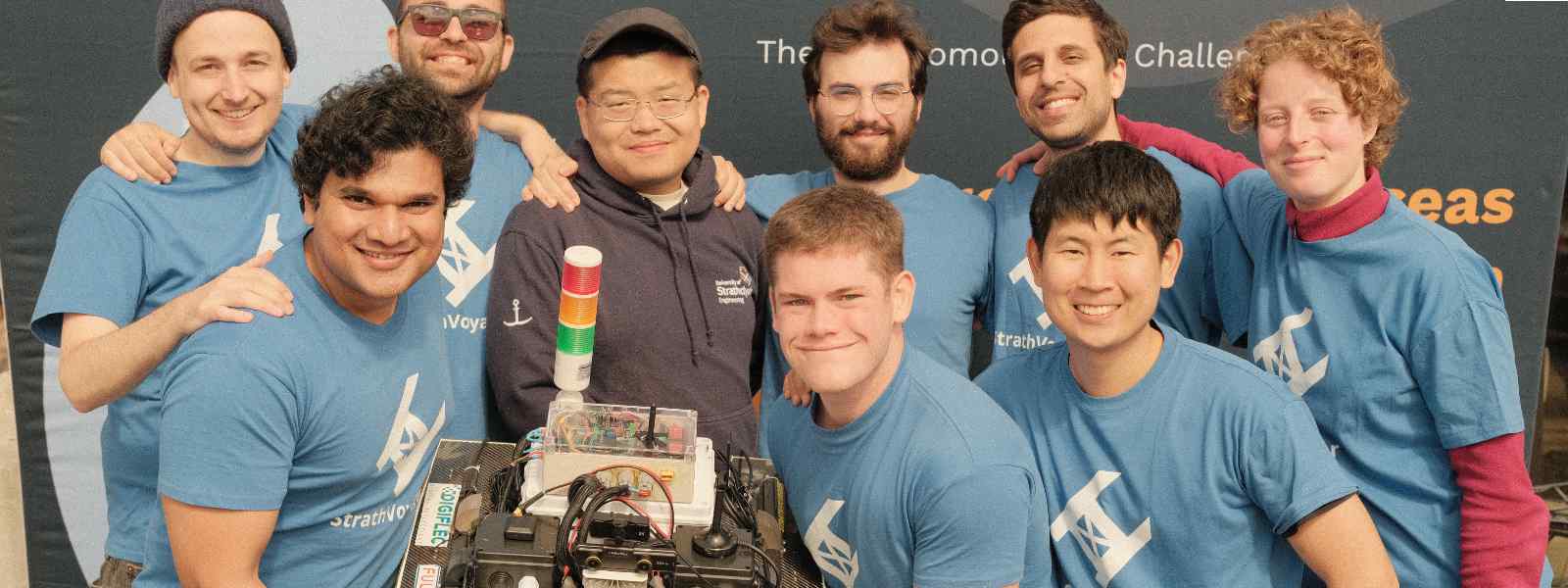The StrathVoyager team with their Autonomous Surface Vehicle. Left to right: Marvin Wright; Nilesh Ohol; Charalampos Tsoumpris; Wang Zhao; Alexander Dixon; Panagiotis Louvros; Mauro Arcidiacono; Paul Lee; Kaja Gorska. Photo Paul Lee The StrathVoyager team with their Autonomous Surface Vehicle. Left to right: Marvin Wright; Nilesh Ohol; Charalampos Tsoumpris; Wang Zhao; Alexander Dixon; Panagiotis Louvros; Mauro Arcidiacono; Paul Lee; Kaja Gorska. Photo Paul Lee
