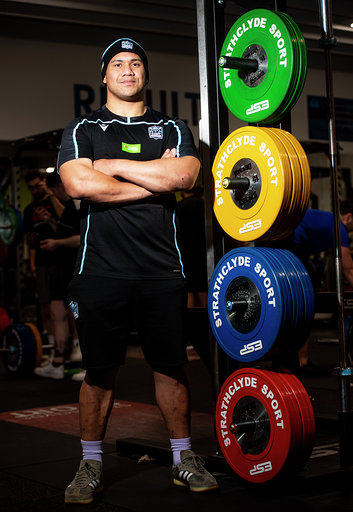 Rugby player standing next to weights in Strathclyde Sport gym