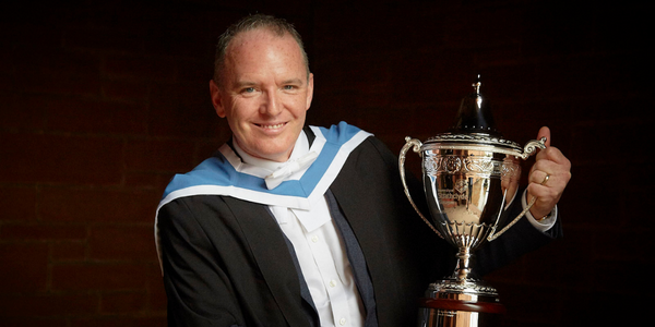 Adrian Gillespie hold his Alumnus of the Year trophy Adrian Gillespie hold his Alumnus of the Year trophy
