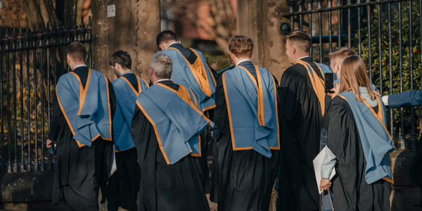 Graduates walking in their academic gowns Graduates walking in their academic gowns