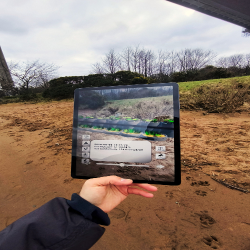 Hand holding an ipad that is scanning the ground Hand holding an ipad that is scanning the ground