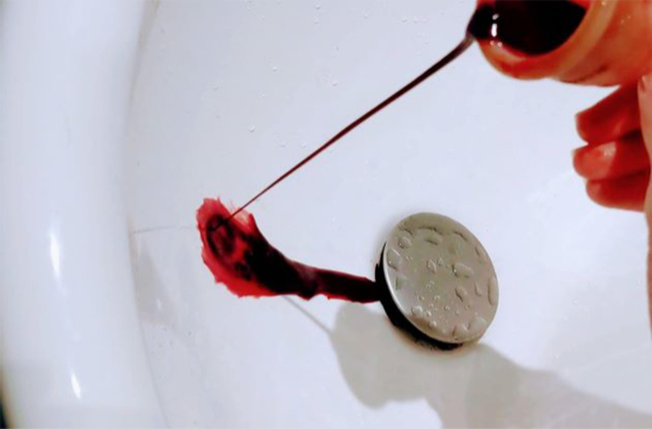 Menstrual cup pouring blood into a sink