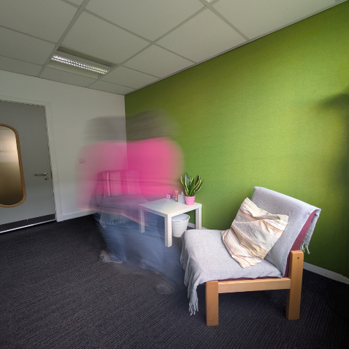 Consulting room with blurred figure moving across it Consulting room with blurred figure moving across it