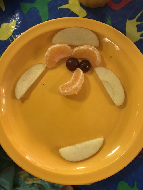 Fruit on a plate in the shape of a smiley face