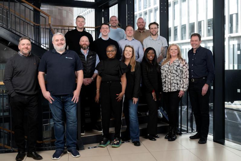 A photograph showing the 14 participants of GAP Cohort 8 standing in a stairwell