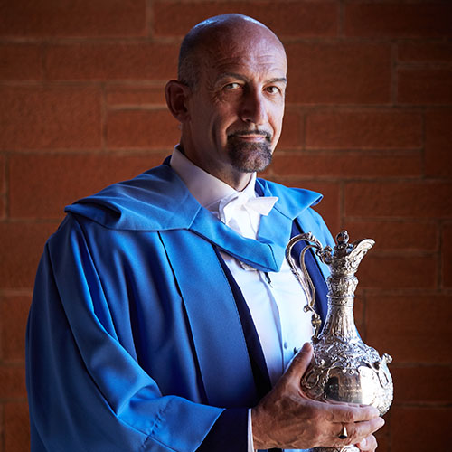 Professor Mario Stevenson with his Alumnus of the Year award