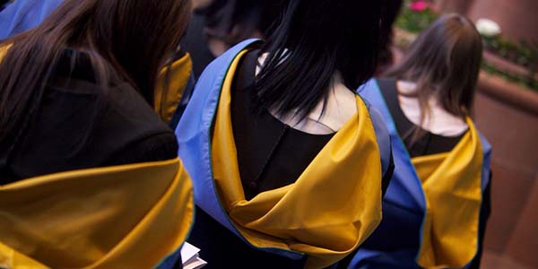 Students with cloaks from behind 600x300 Students with cloaks from behind 600x300