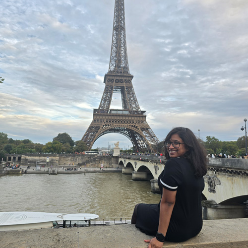 Kezhia smiling with the Eiffel Tower in the background Kezhia smiling with the Eiffel Tower in the background