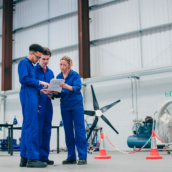 a group of engineers stand together in discussion a group of engineers stand together in discussion