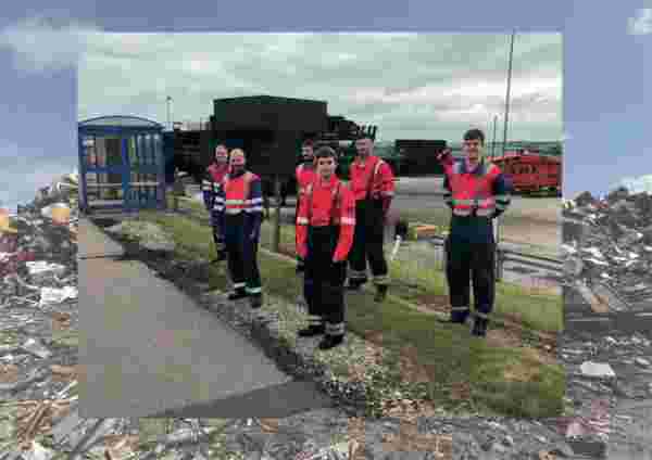 Men in high vis work gear stand at the side of a path Men in high vis work gear stand at the side of a path