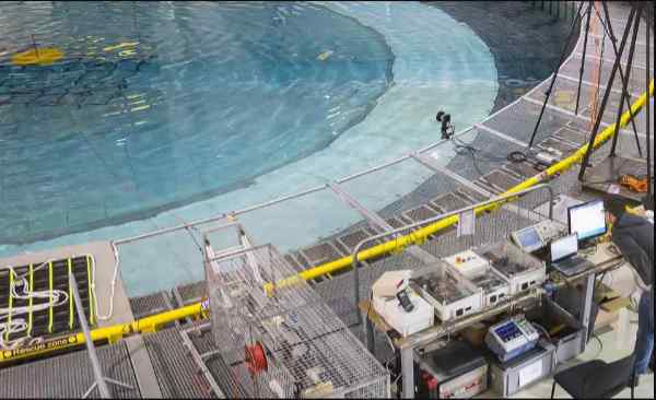 Scientific equipment around a circular pool of water Scientific equipment around a circular pool of water