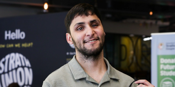 Abdul smiling inside the Strath Union building